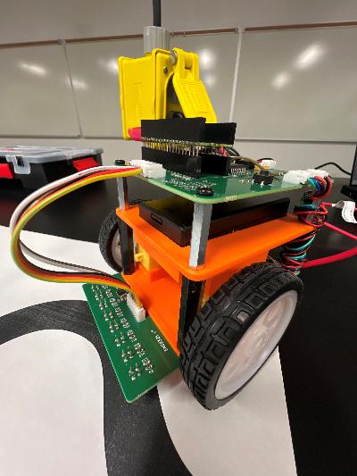 The assembled line-following robot on a black course with a white line.